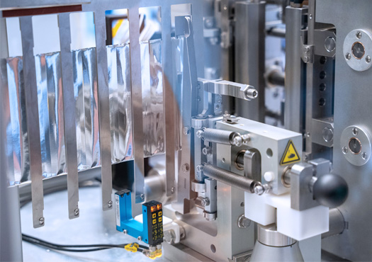 Das Foto gewährt einen Einblick in das Laborprüfgerät zur Analyse von Schneidprozessen von Verpackungsfolien. 