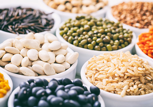 Assorted legumes in white bowls 