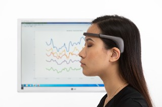 Woman with EEG headband for brain activity measurement.