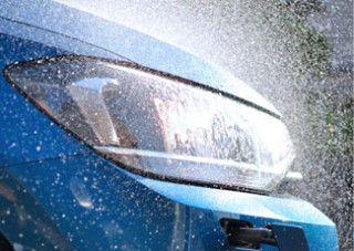 View of a vehicle headlight being contaminated with spray mist