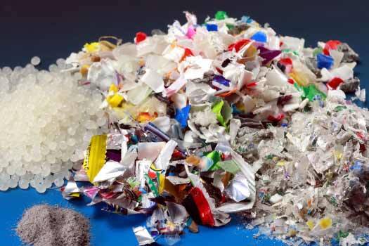 Various shredded colorful packaging materials and recyclates made from them.