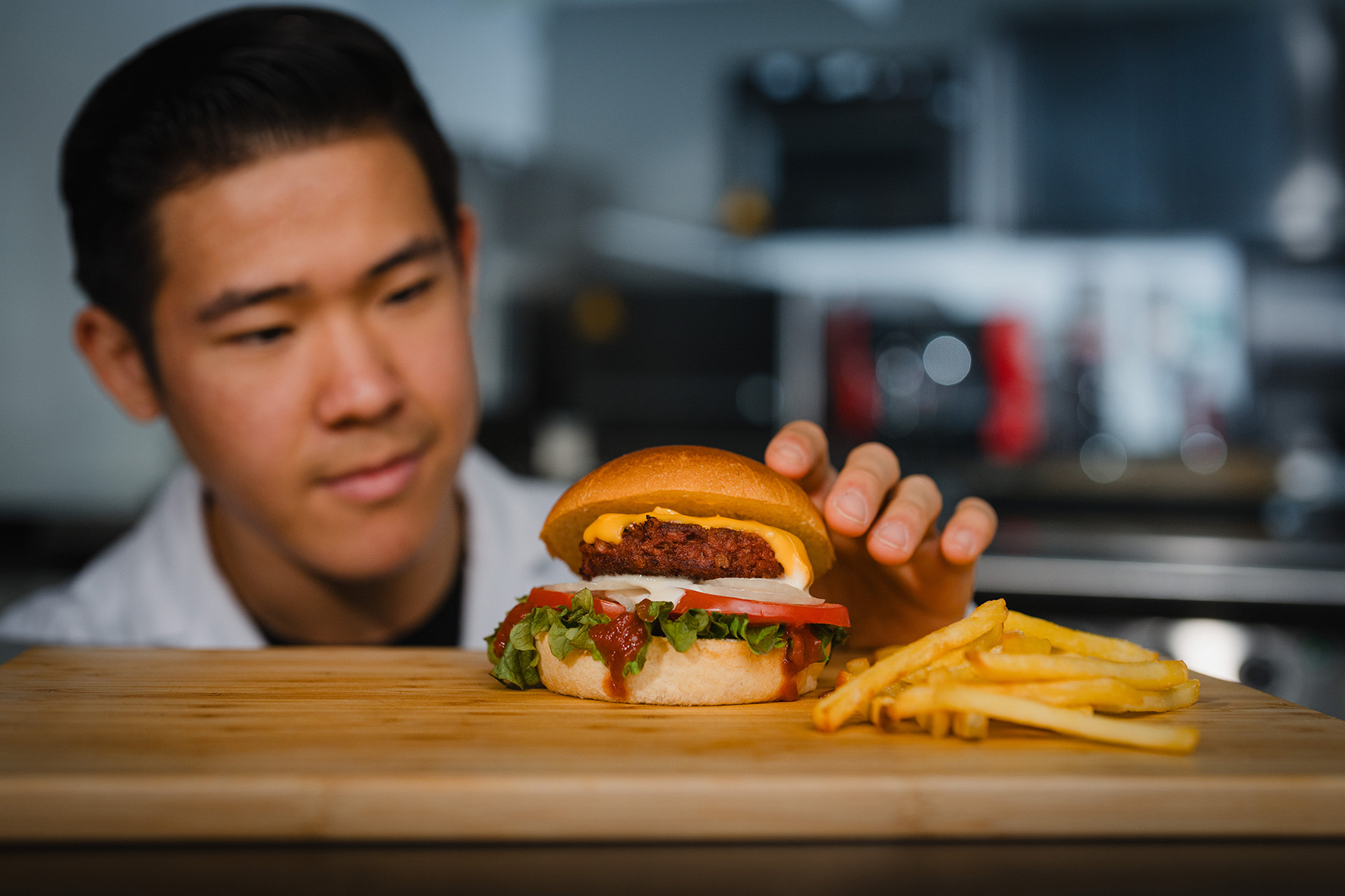 Vegan meat alternative A burger with vegan patty and fries on a cutting board