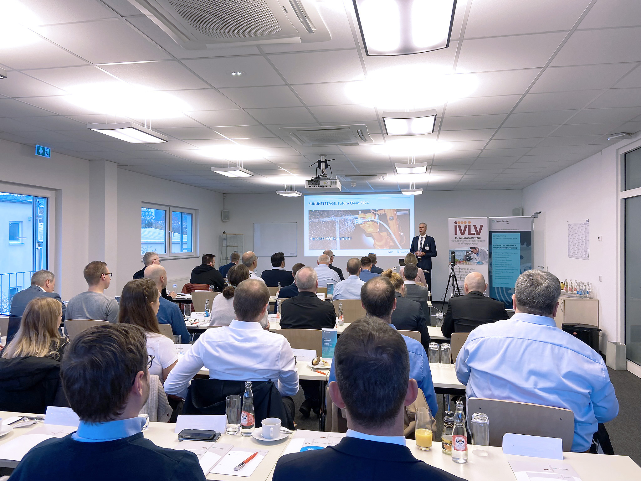 Foto der Vortragssession der Future Clean 2024. Im Vordergrund sind die Teilnehmenden zu sehen, die auf die Präsentation schauen.