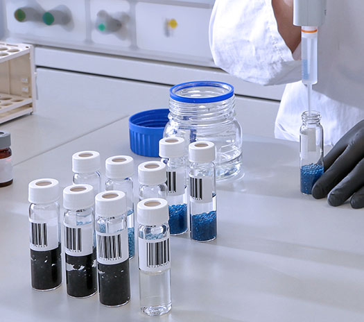 Several analytical samples are filled with liquid by laboratory staff