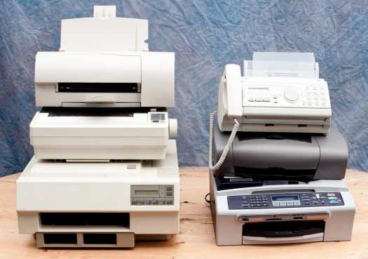 Group of outdated printers, scanners, and fax machines